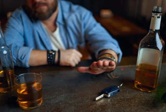 Intoxicated driver with car keys - dram shop liability Intoxicated man reaching for car keys after being over-served alcohol at a bar
